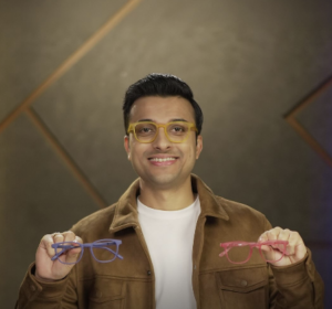 Featured Image: A vibrant, colorful design with Aashish Solanki smiling on stage, holding a microphone, with a spotlight on him. The background has a comedy club vibe with a crowd laughing. Bold text overlay reads: “Aashish Solanki: Comedy Star’s Net Worth & Family Secrets!” in a fun, yellow font. Include his YouTube logo and Shark Tank India logo in the corners for branding.